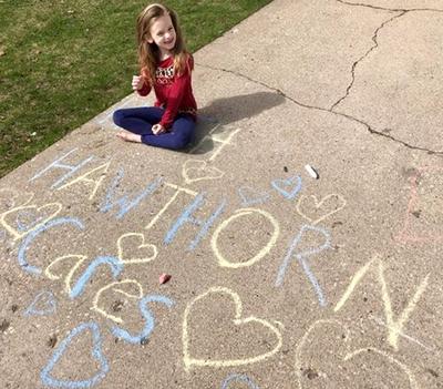 Photo of child with chalk drawing